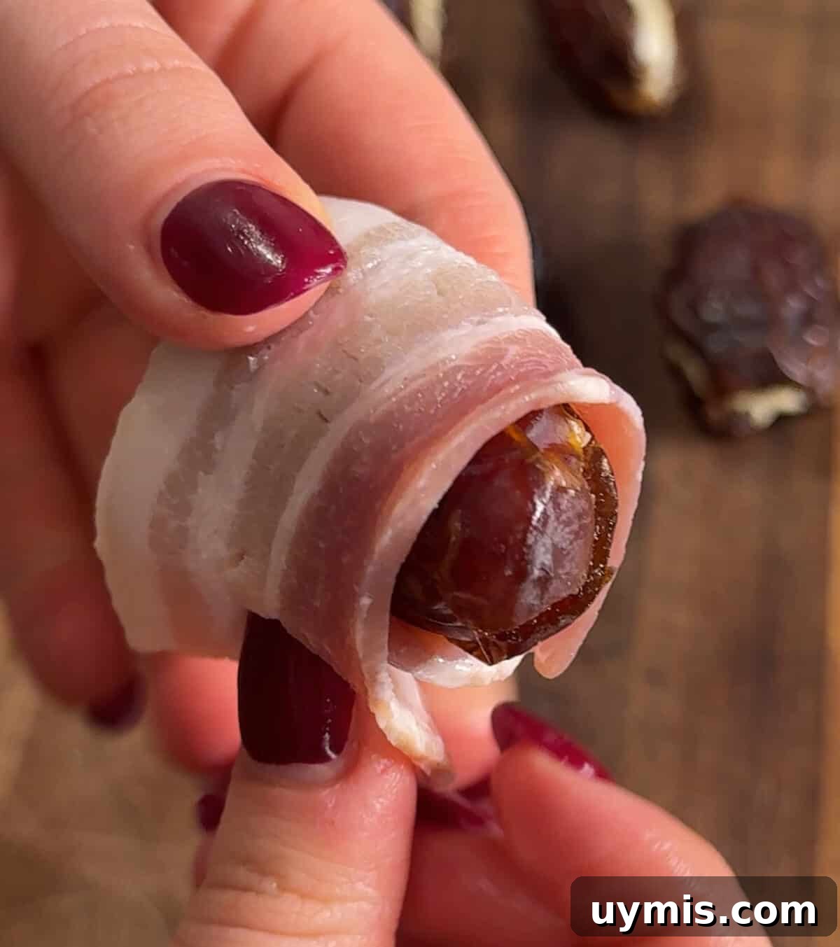 Crispy bacon wrapped dates served on a platter