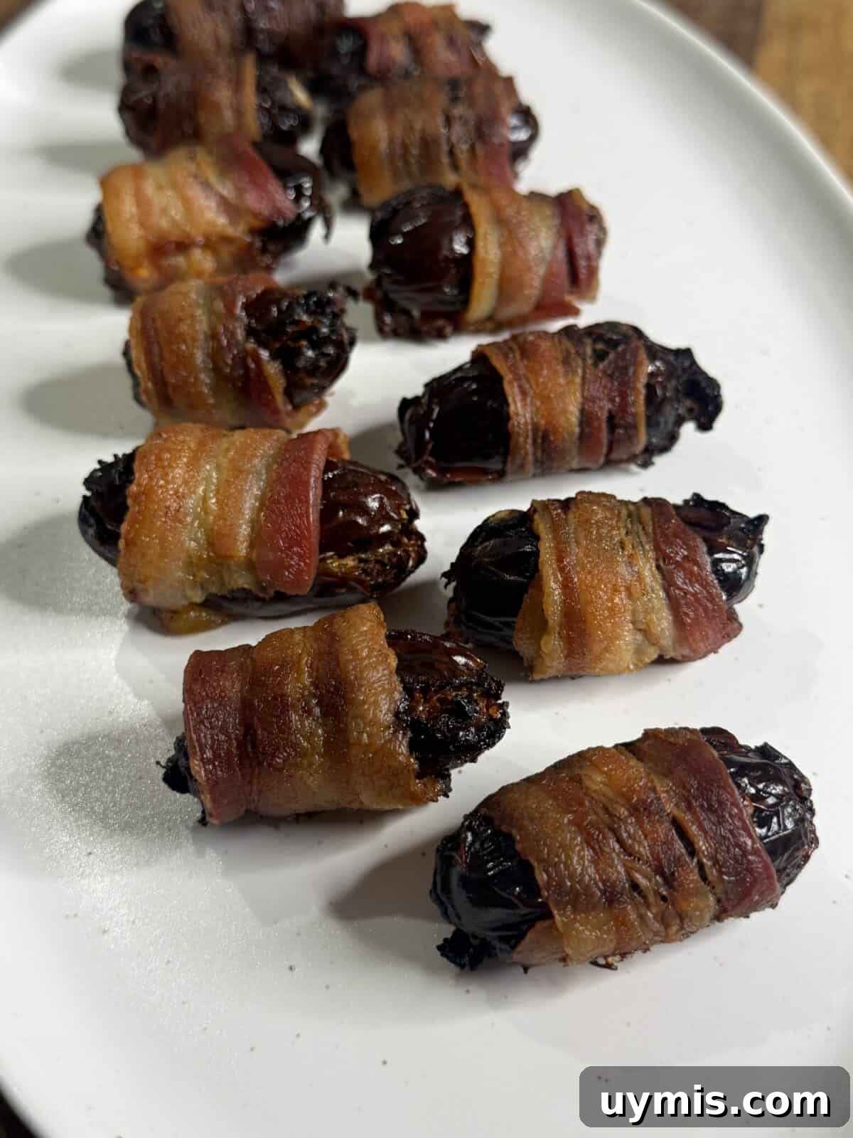 Prepared bacon wrapped dates cooling on a rack