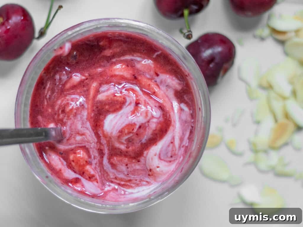 mixed puree in a mason jar with cherries around
