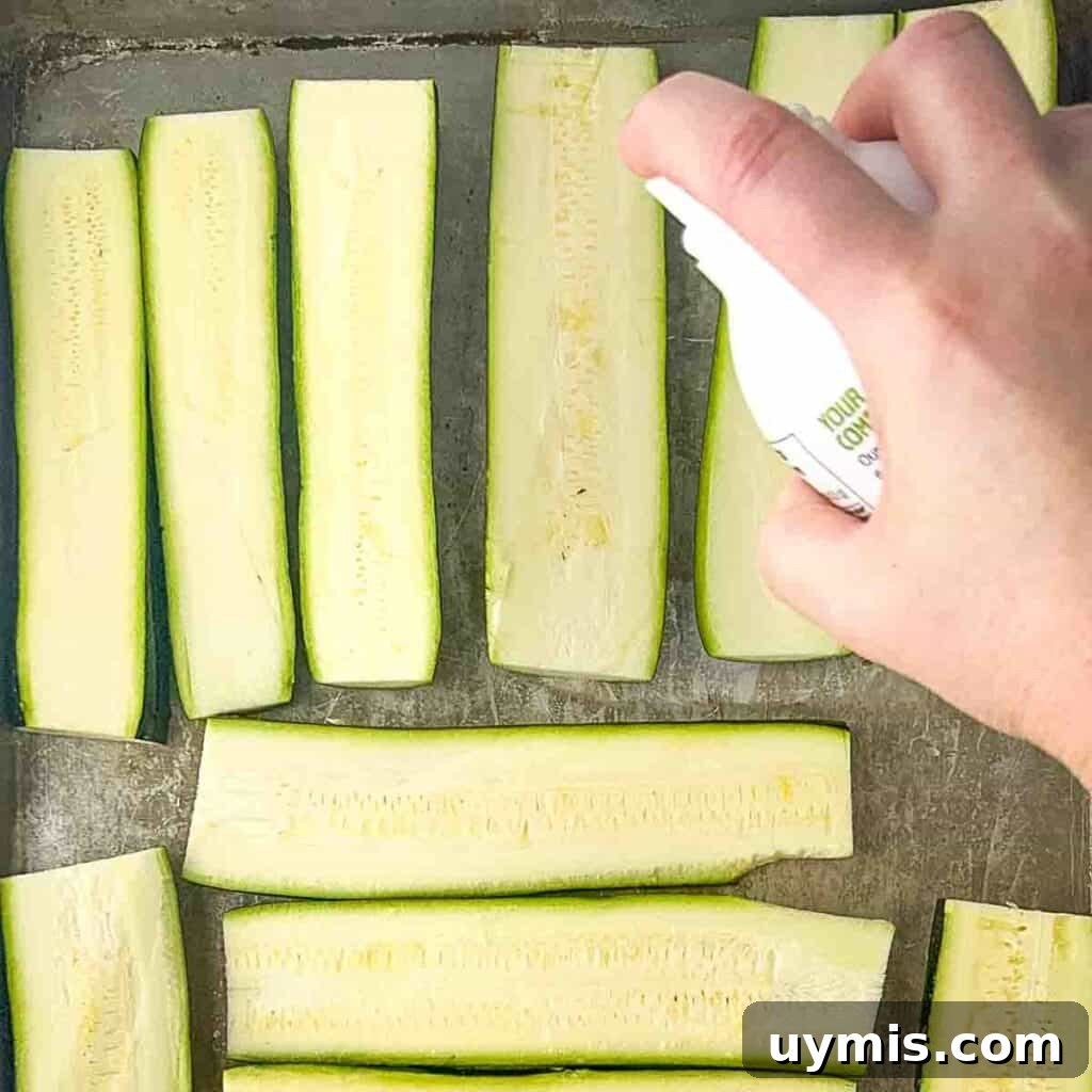 How to Smoke Zucchini on a Pellet Grill 5 Spraying the zucchini slices with avocado oil, ensuring they are evenly coated..
