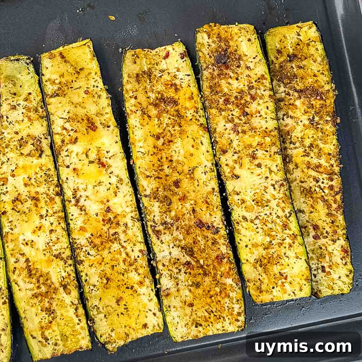 How to Smoke Zucchini on a Pellet Grill 10 Perfectly cooked zucchini slices on a serving tray.