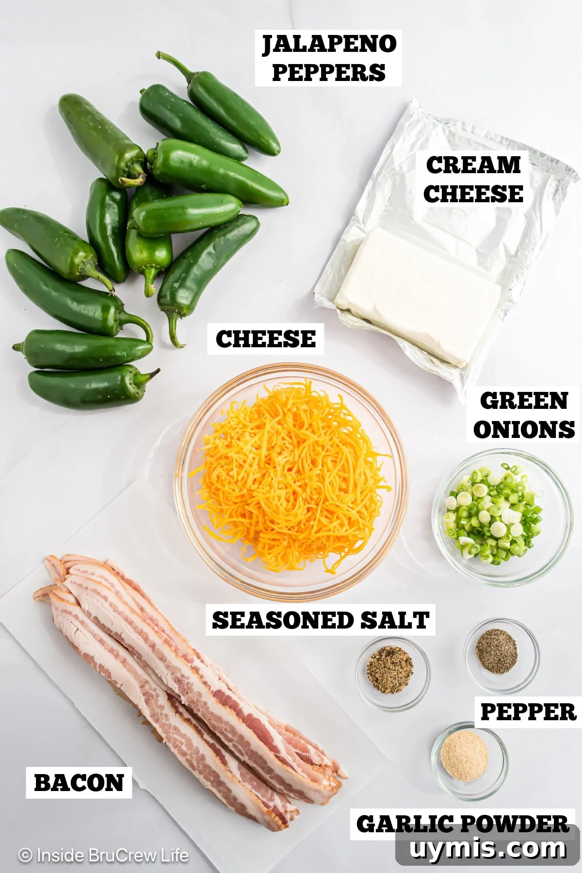 A white board with bowls of ingredients needed to make stuffed jalapenos.