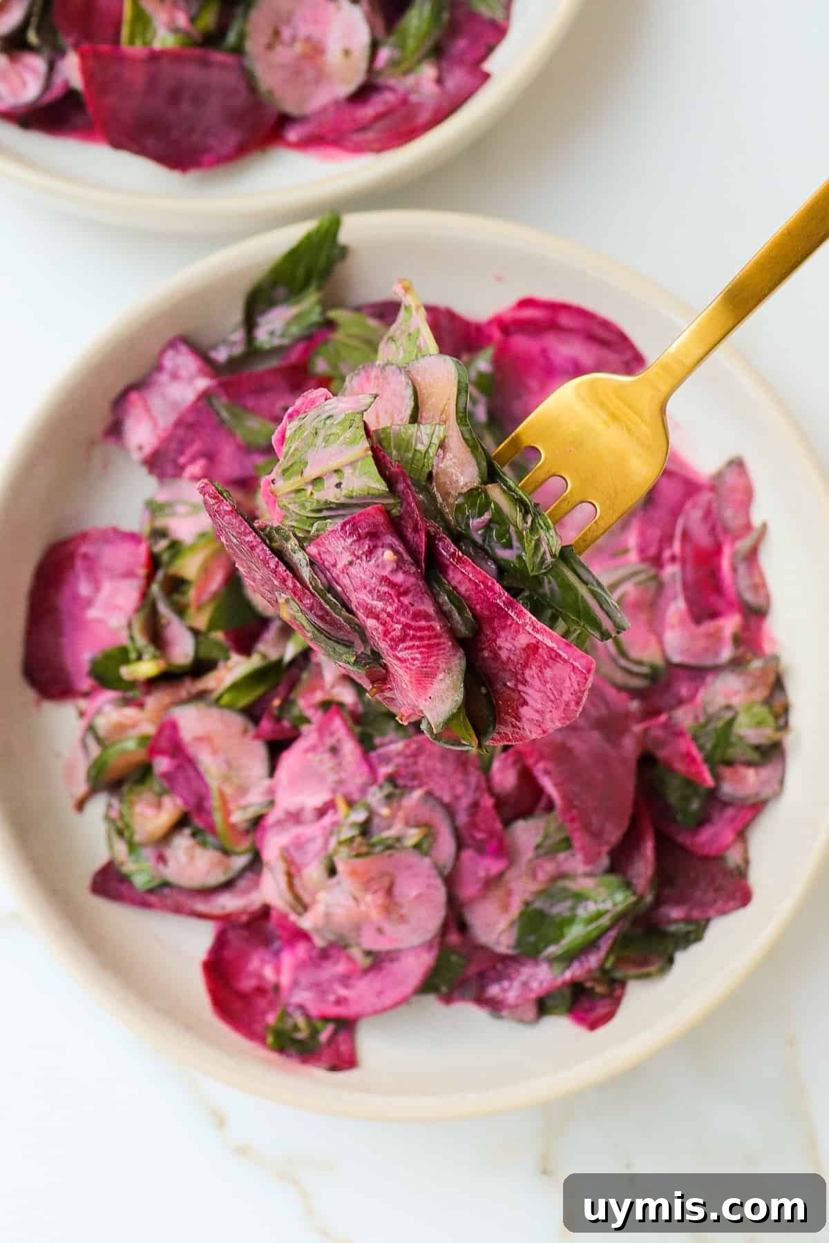 Cucumber and Beetroot Salad Recipe 3 Close up shot of salad on a fork.