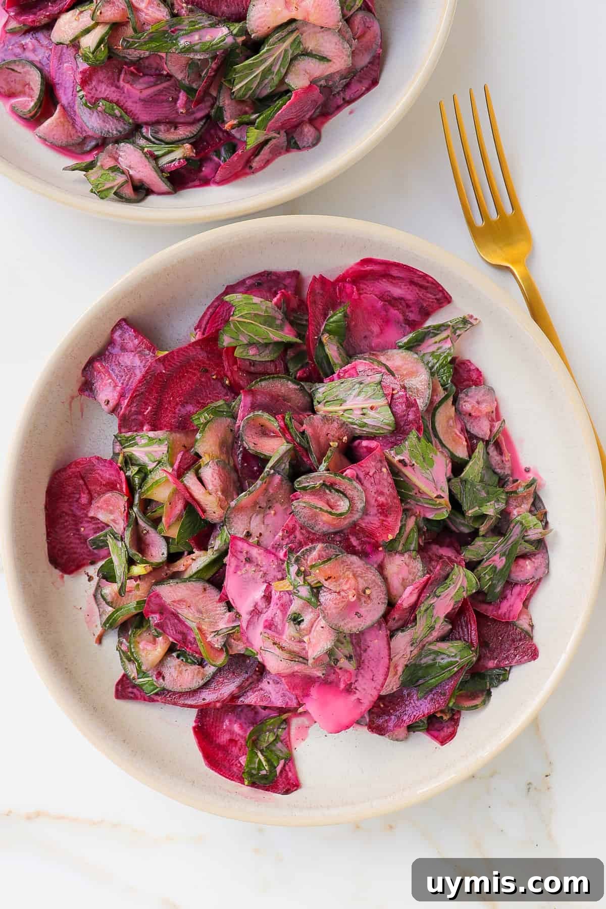 Cucumber and Beetroot Salad Recipe 8 Beetroot salad in a bowl with gold spoon non the side.