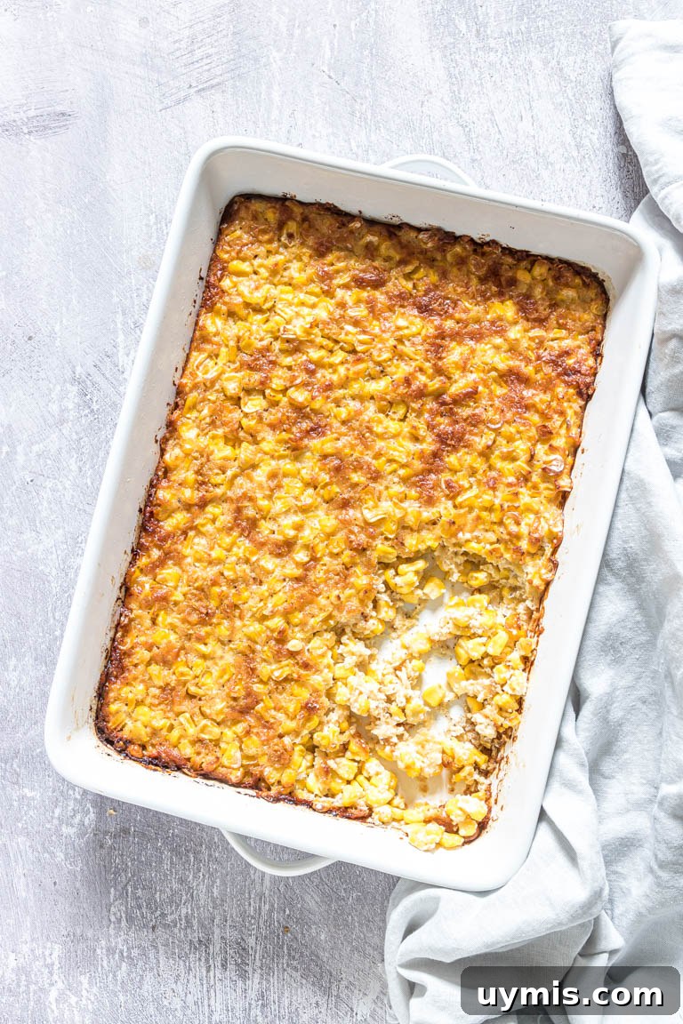 Creamy Scalloped Corn Casserole Recipe 2 the finished scalloped corn recipe inside a white baking dish