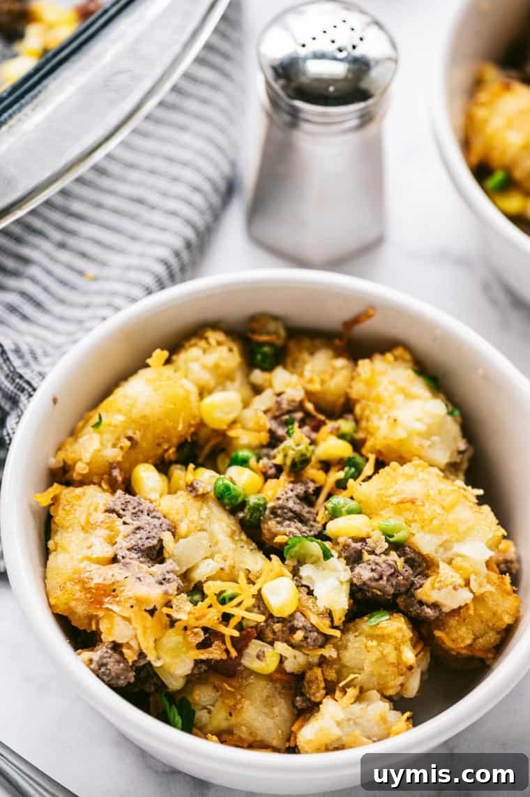 Creamy Scalloped Corn Casserole Recipe 8 a serving of tater tot casserole in a white dish