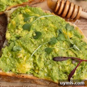 Hot Honey Avocado Toast Recipe 8 This is a square picture of a close up avocado toast with honey.