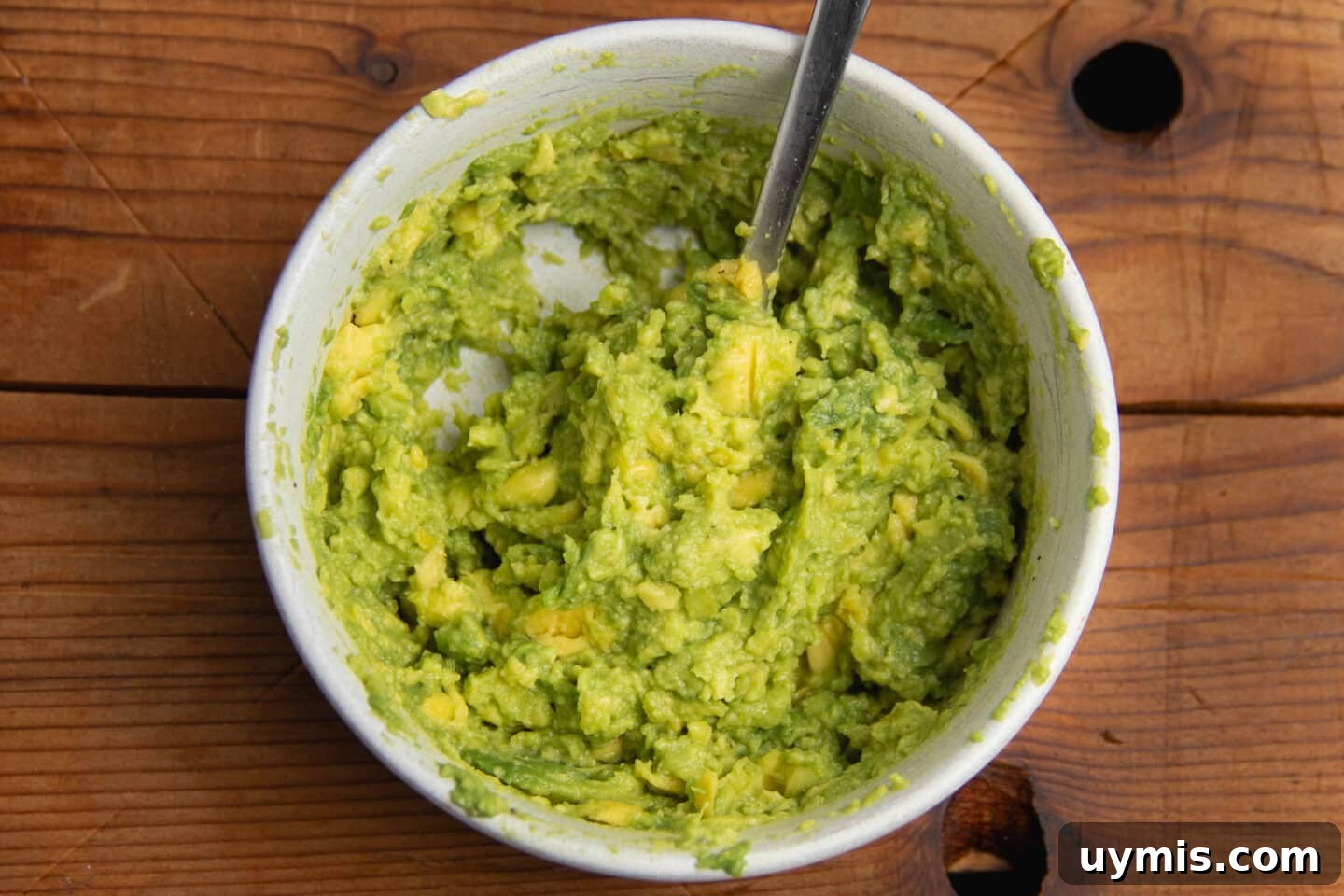Hot Honey Avocado Toast Recipe 4 This is a picture of a bowl with smashed avocado.