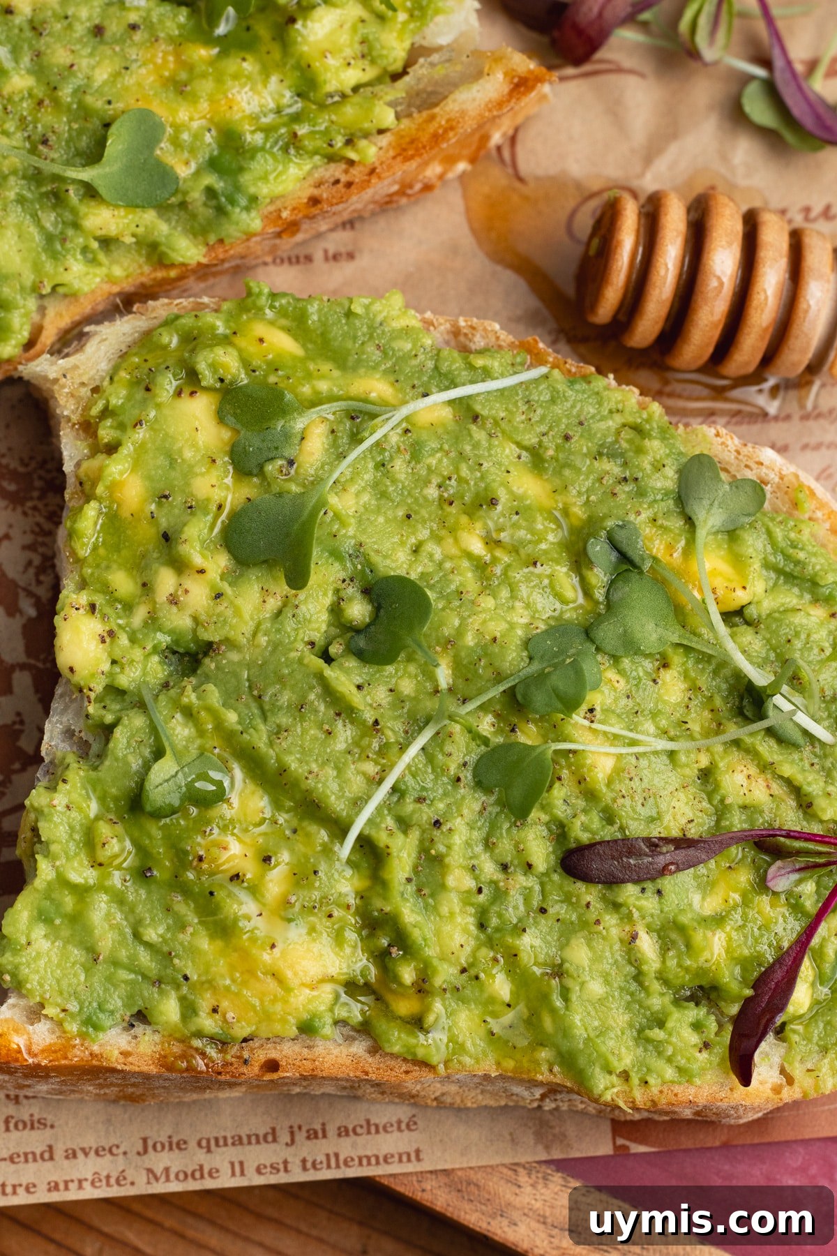 Hot Honey Avocado Toast Recipe 6 This is a picture of a toast with avocado and honey.
