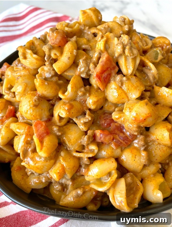Taco Macaroni and Cheese Skillet Dinner 2 Taco macaroni and cheese made with seasoned ground beef and boxed macaroni for an easy family dinner.