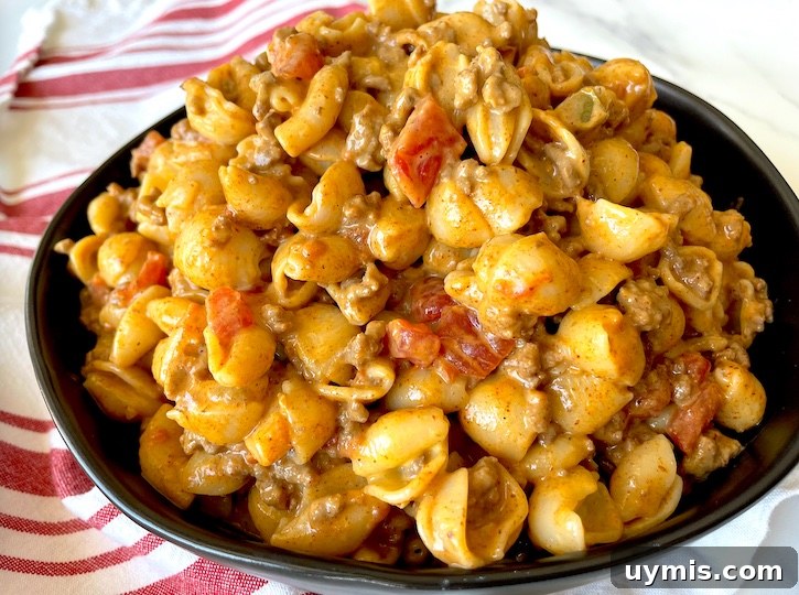 Taco Macaroni and Cheese Skillet Dinner 4 A skillet of cheesy taco macaroni with seasoned ground beef for a quick weeknight dinner.