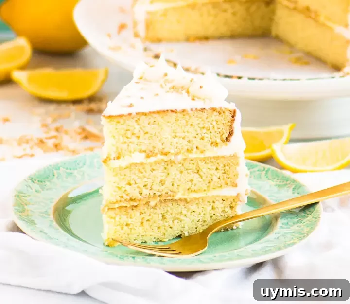 Lemon Coconut Cake with Creamy Coconut Frosting 2 slice of coconut lemon cake on a plate with the cake on a cake stand behind it