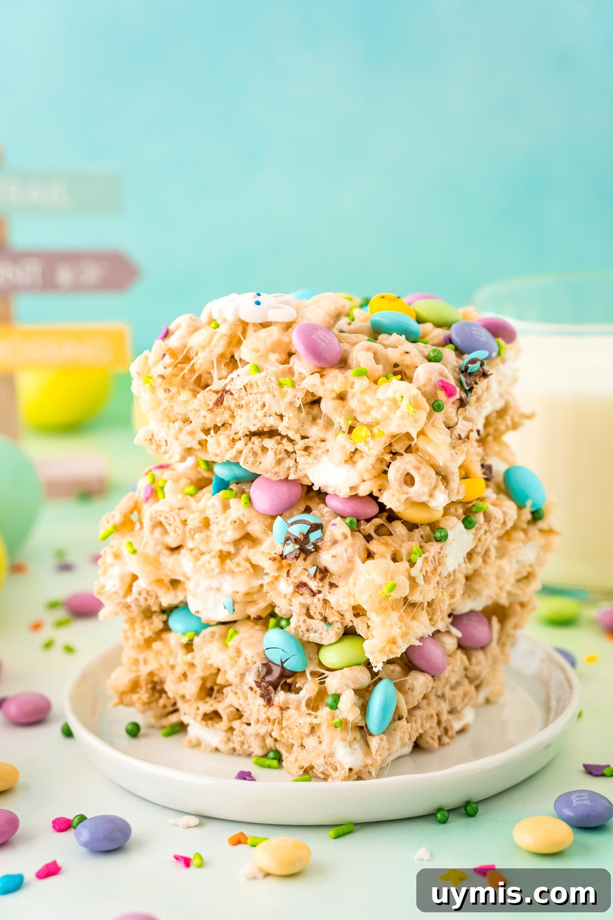 Egg Shaped Rice Krispie Treats for Easter 3 Close up photo of a stack of three Easter rice krispie treats on a white plate.
