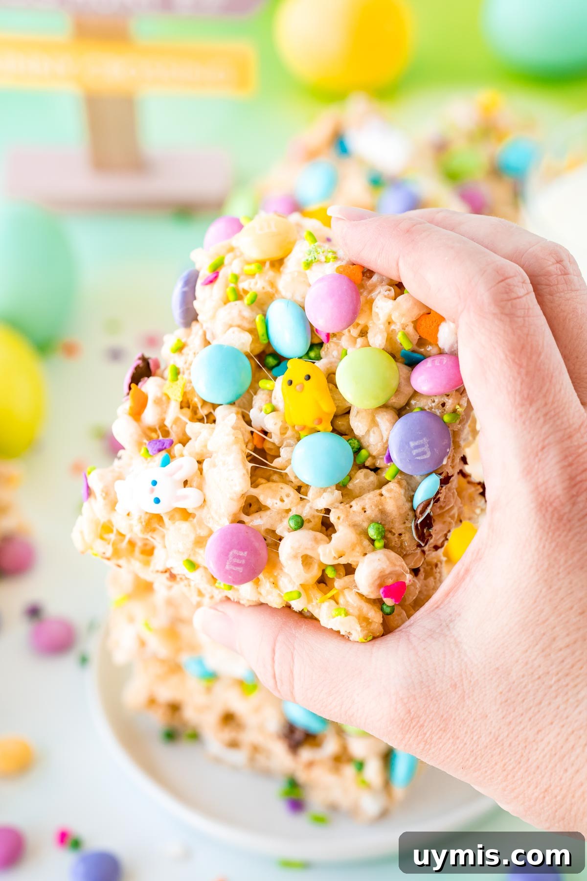 Egg Shaped Rice Krispie Treats for Easter 6 A woman's hand holding a Easter rice krispie treat to the camera.