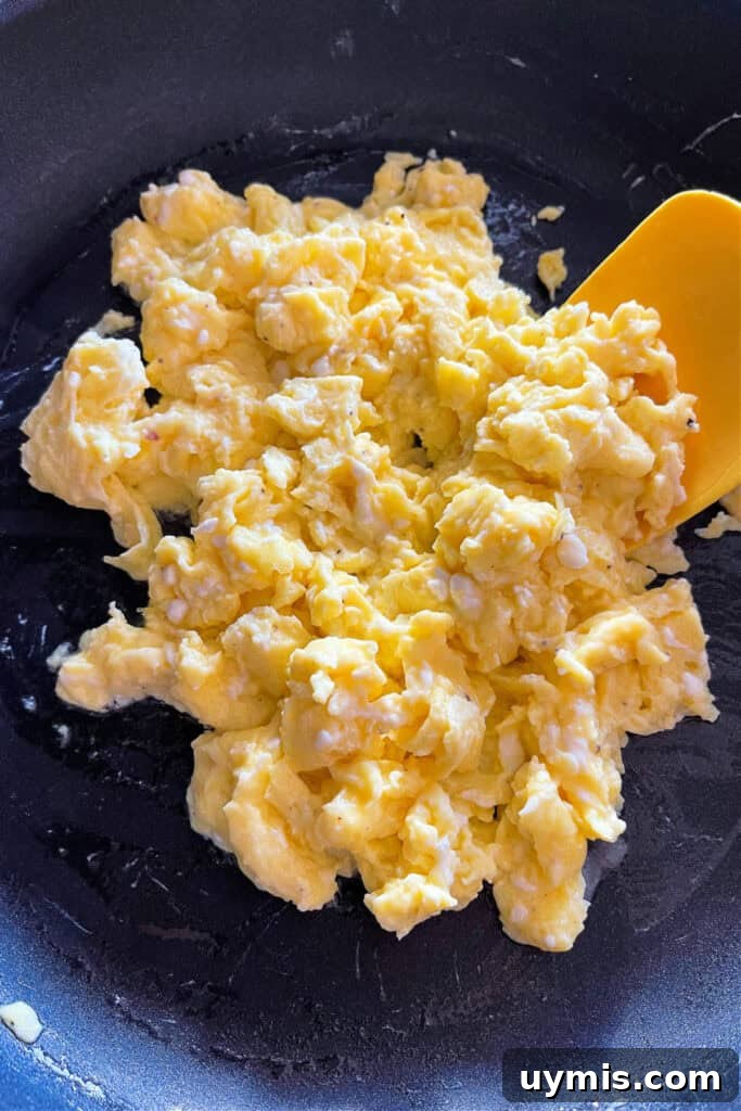 scrambled eggs in skillet with spatula
