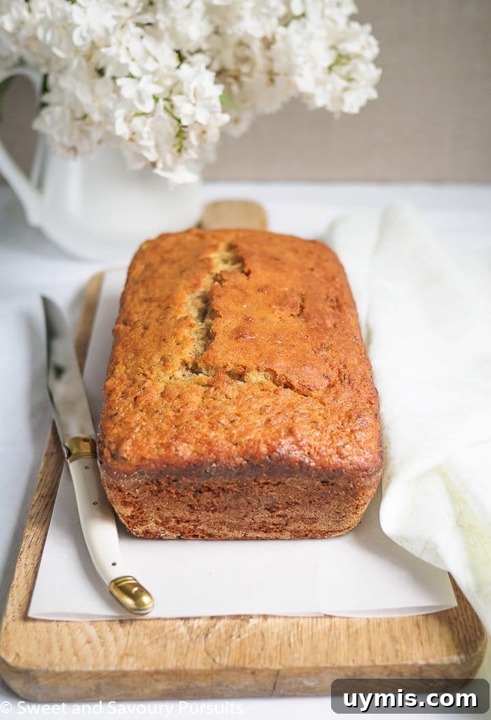 Zesty Lemon Zucchini Loaf Recipe 2 A Lemon Zucchini Loaf on a cutting board.