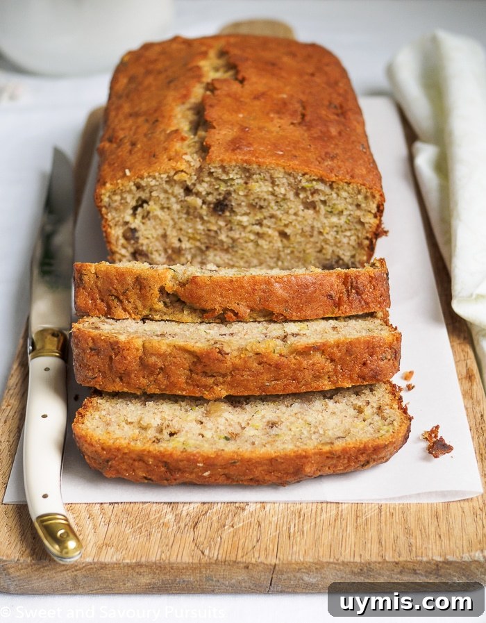 Zesty Lemon Zucchini Loaf Recipe 4 Close-up of a Sliced Lemon Zucchini Loaf on cutting board.