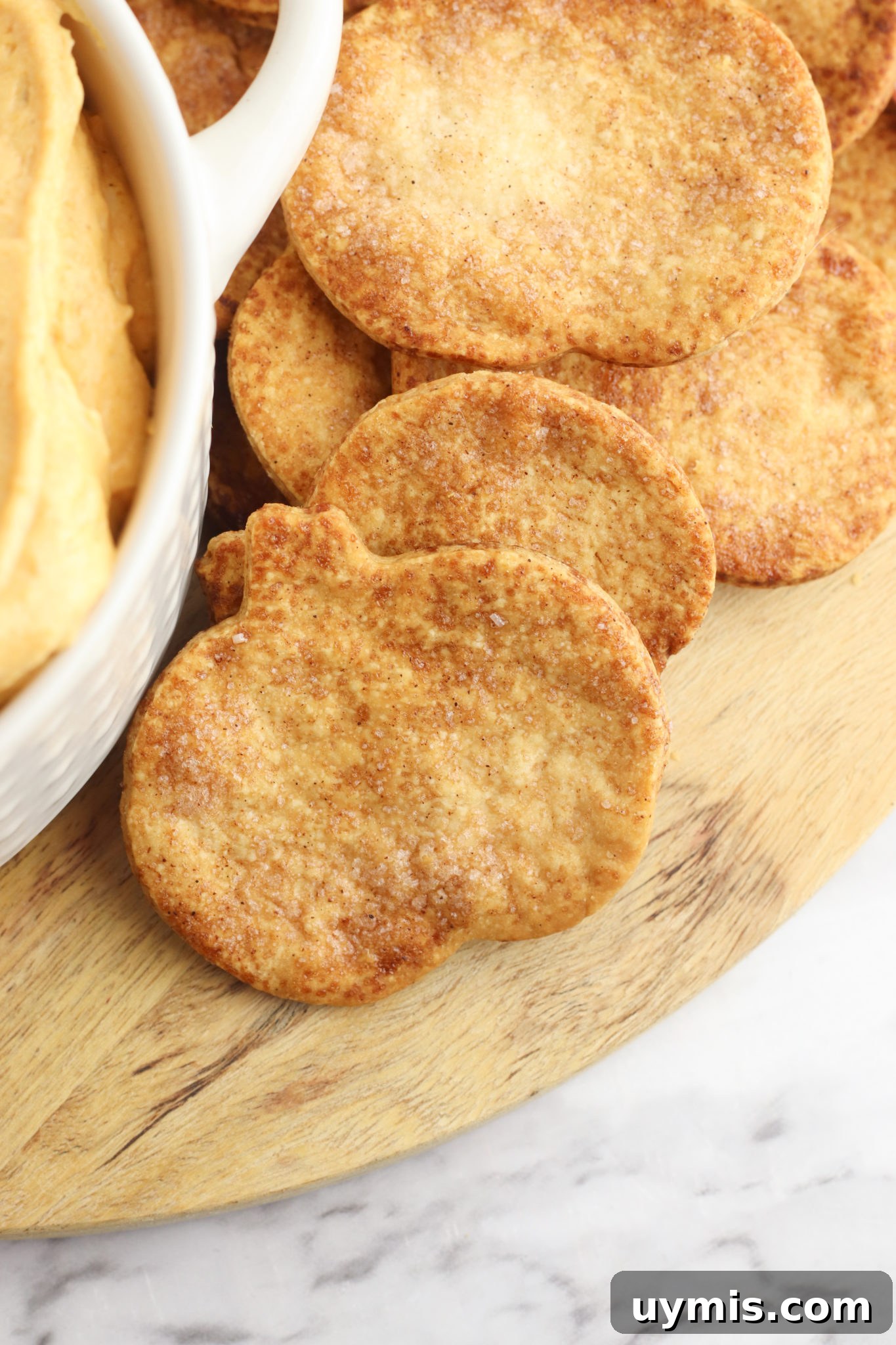Flaky Pie Crust Crackers Recipe 2 Pie Crust Crackers with a side of dip in a white crock.