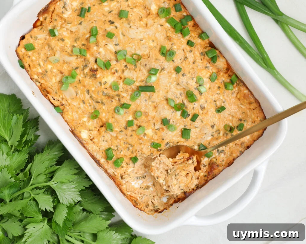 Creamy Buffalo Chicken Dip Recipe for Game Day 2 Creamy buffalo chicken dip baked in a white dish and topped with chopped green onions, served hot and ready for dipping.