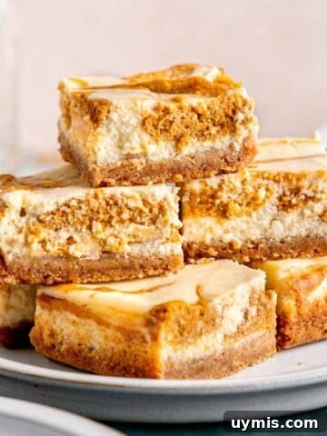 A stack of pumpkin cheesecake bars on a plate.