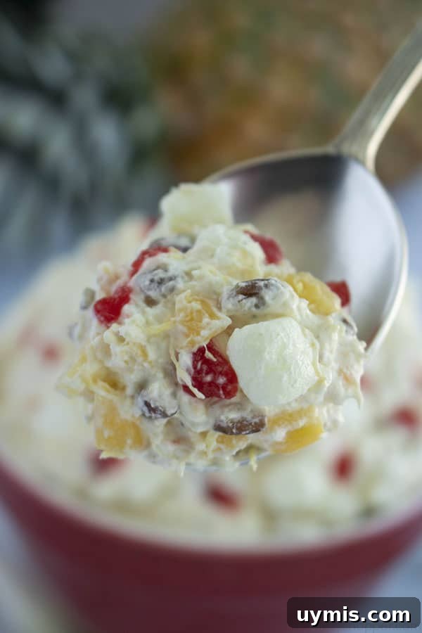 Fluffy Pineapple Salad with Marshmallows and Whipped Cream 5 Spoon closeup of fluffy salad