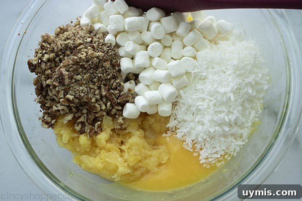 Fluffy Pineapple Salad with Marshmallows and Whipped Cream 9 Ingredients for for salad with pineapple in a bowl