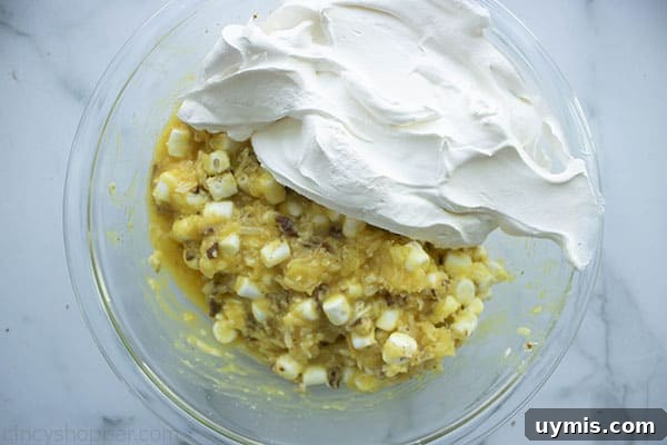 Fluffy Pineapple Salad with Marshmallows and Whipped Cream 10 pineapple mixture in bowl with whipped topping
