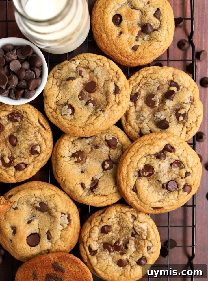 No-Chill Chocolate Chip Cookie Recipe 10 best brown butter chocolate chip cookies on cooling rack with glass of milk and bowl of chocolate chips