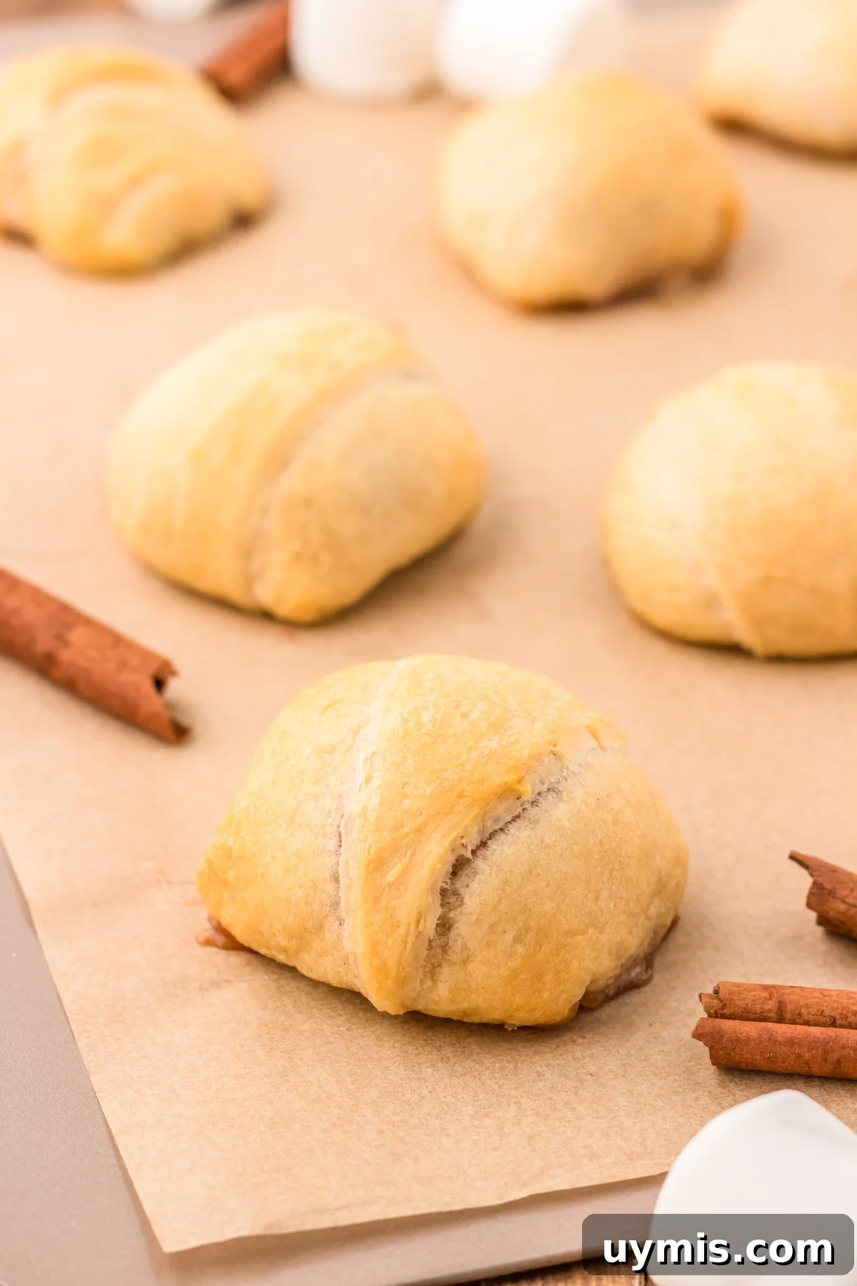 Easter Resurrection Rolls with Marshmallow Center 6 Baked Resurrection rolls on a baking sheet.