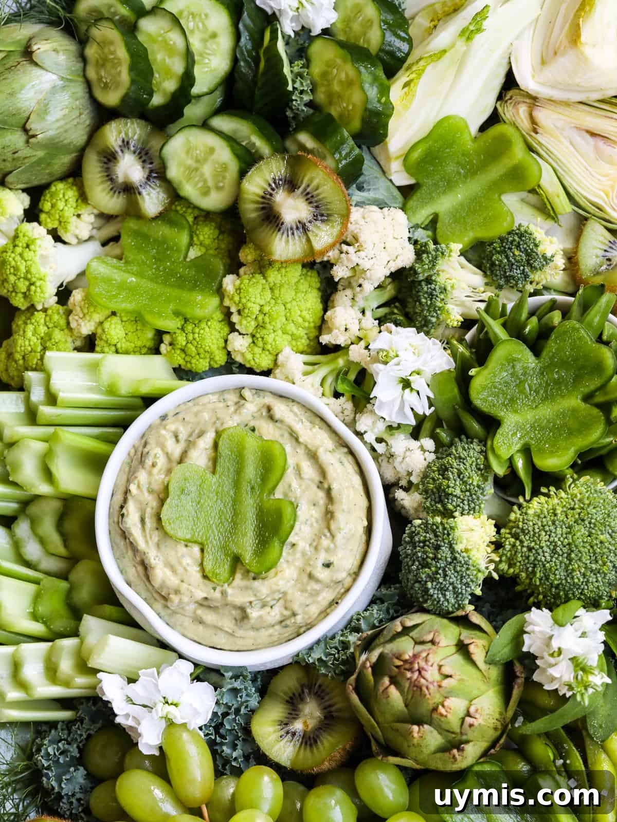 St. Patrick's Day Green Snack Ideas for Parties 6 An all green vegetable tray for St. Patrick's Day with cut veggies and fruit with a dip.