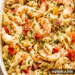 Creamy Baked Shrimp Pasta with Cream Cheese 8 white baking dish with shrimp and pasta tossed with a cream cheese sauce and cherry tomatoes