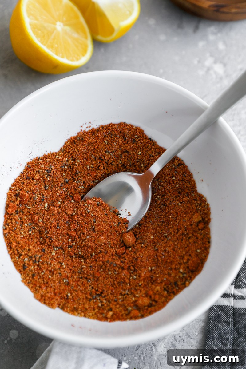 Oven-Baked Brown Sugar-Spiced Salmon 4 A white bowl filled with a homemade spice rub made with coconut sugr or brown sugar, paprika, salt and black pepper