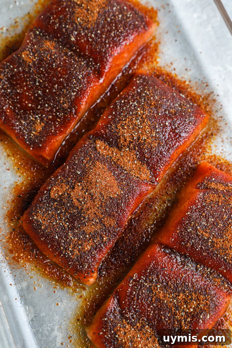 Oven-Baked Brown Sugar-Spiced Salmon 5 3 fresh salmon fillets sprinkled with a sweet and spicy dry rub sitting in a clear baking dish