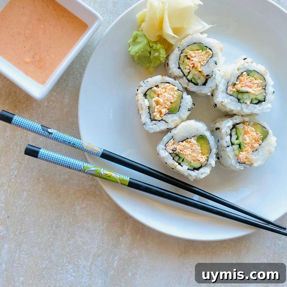How to Make Spicy Kani Roll — Japanese Crab Sushi 6 kani salad roll on a plate with chopsticks
