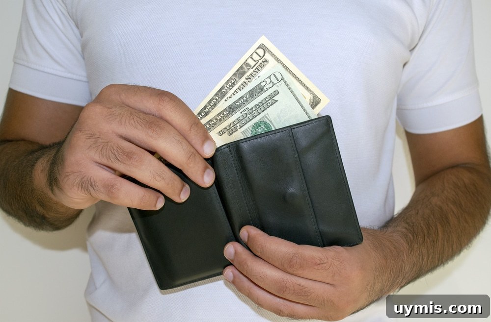 Man putting a $10 and $20 bill into his wallet