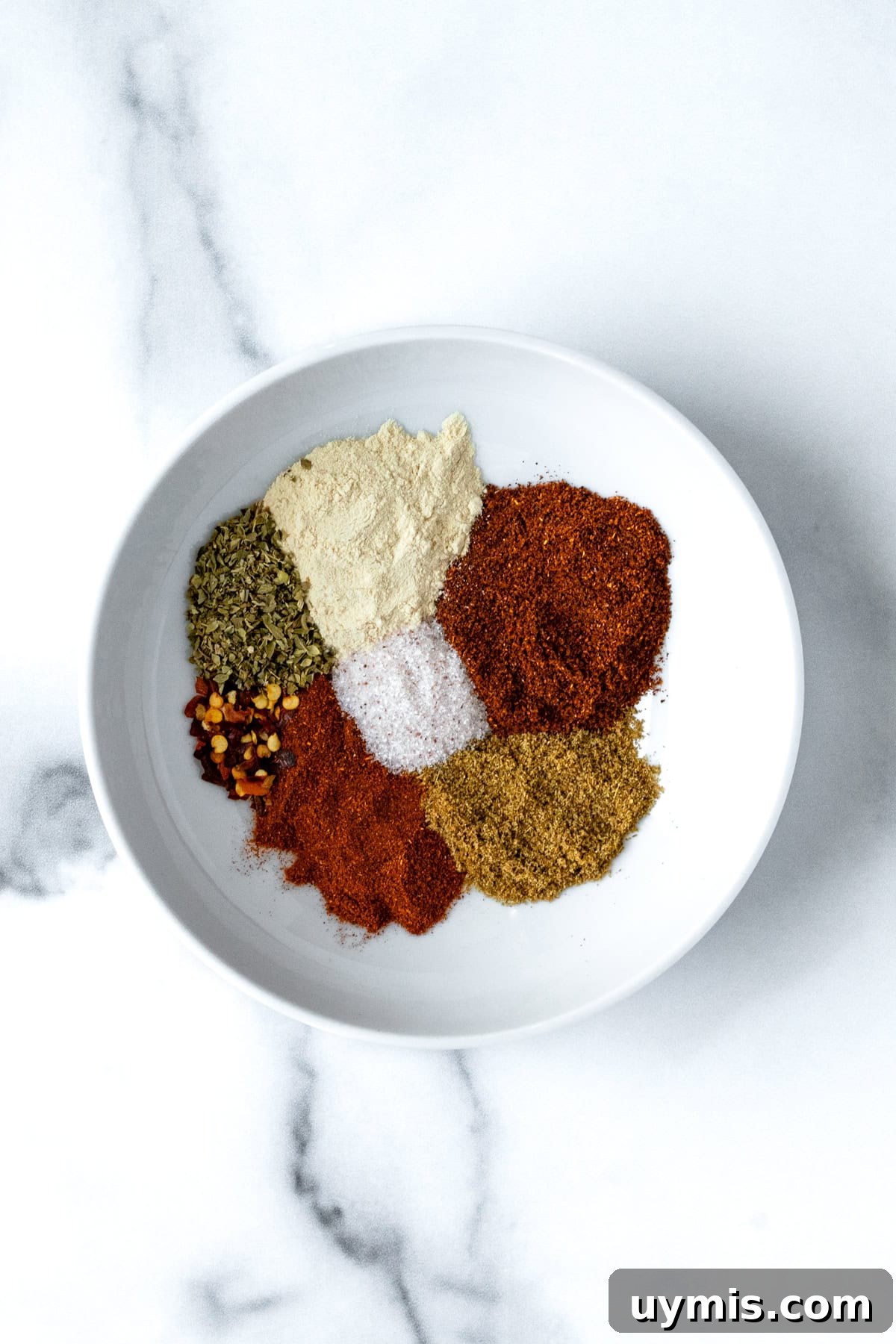 Homemade Ground Turkey Taco Seasoning Mix 3 Ground Turkey Taco Seasoning Ingredients on a small white plate.