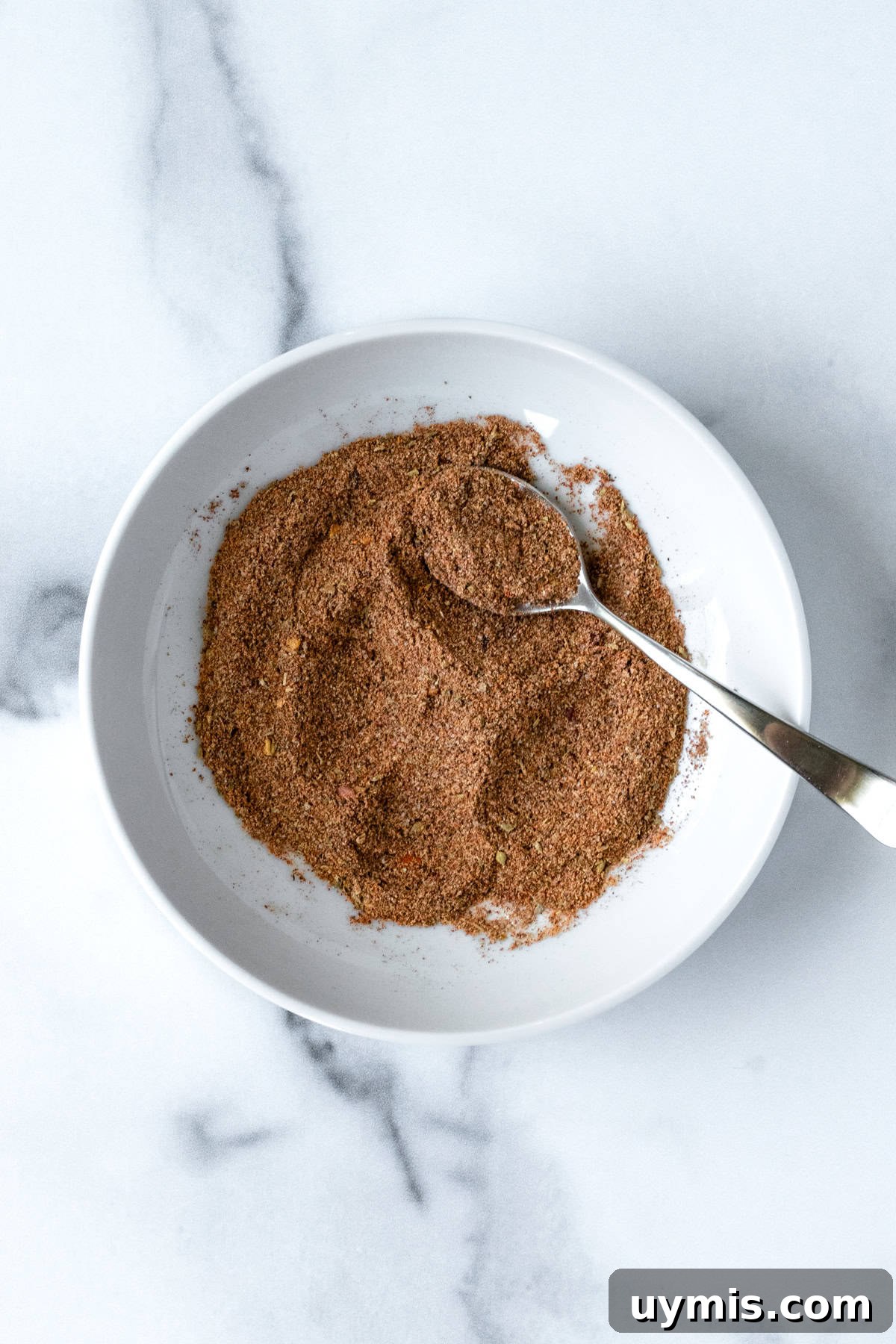 Homemade Ground Turkey Taco Seasoning Mix 5 Homemade Ground Turkey Taco Seasoning in a white bowl with a spoon.