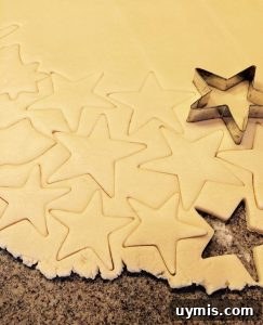 Cut star-shaped cookie dough on a floured surface