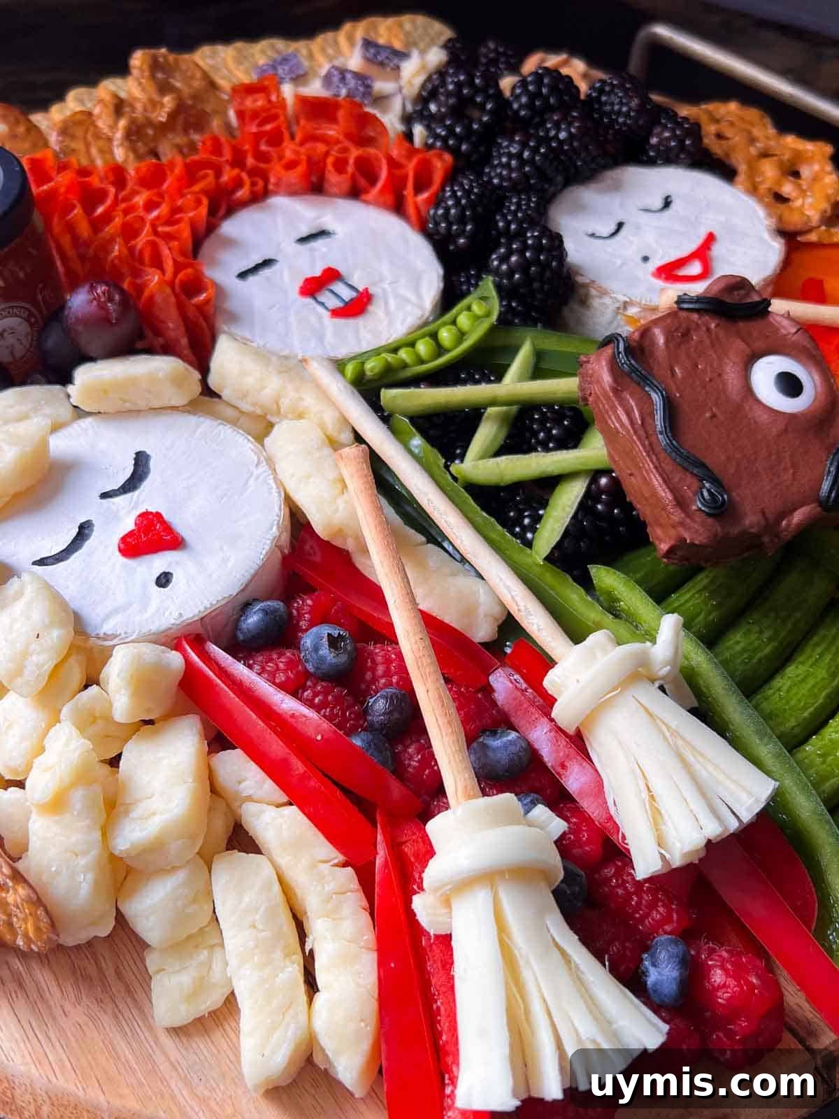 Sanderson Sisters Snack Board for a Hocus Pocus Party 4 up close view of sanderson sisters charcuterie board hocus pocus halloween party food