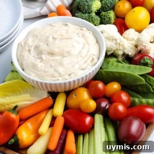 closeup view of crudite board with a bowl of creamy dip.