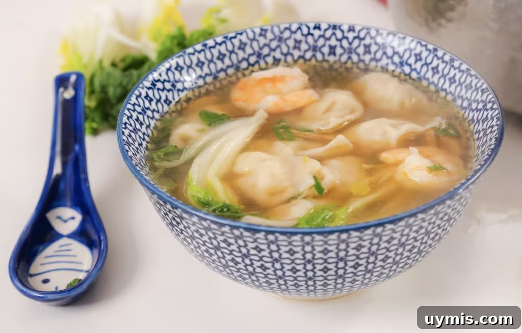 Homemade Wonton Soup Recipe with Pork and Shrimp 2 Homemade Wonton Soup in a white and blue china bowl.