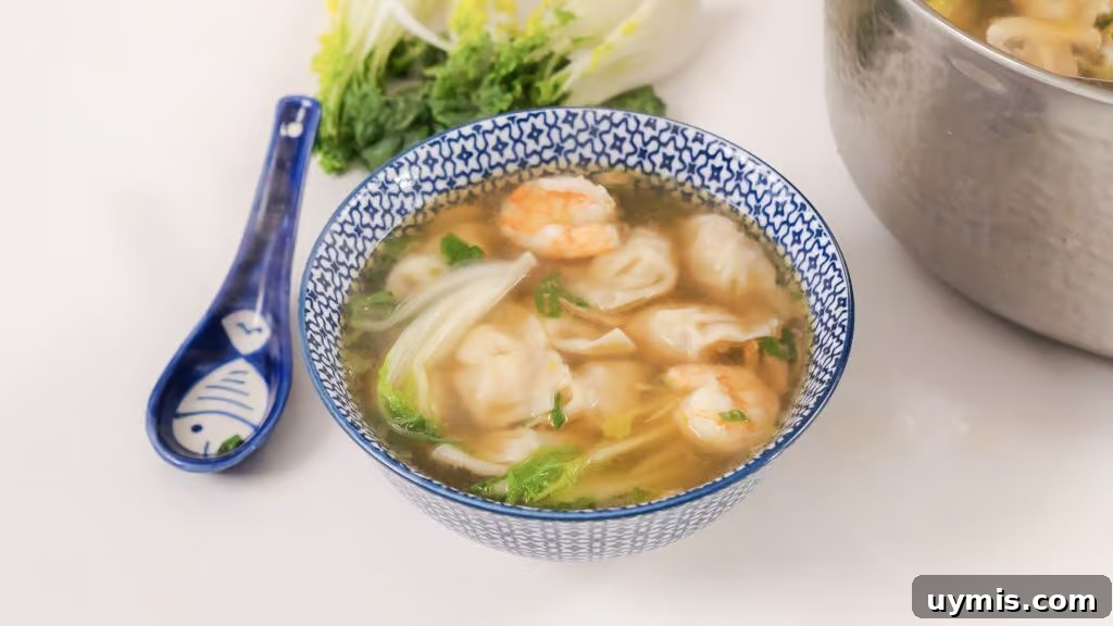 Homemade Wonton Soup Recipe with Pork and Shrimp 3 Homemade Wonton Soup in a white and blue china bowl.