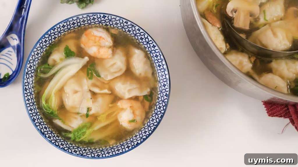 Homemade Wonton Soup Recipe with Pork and Shrimp 4 Homemade Wonton Soup in a white and blue china bowl.
