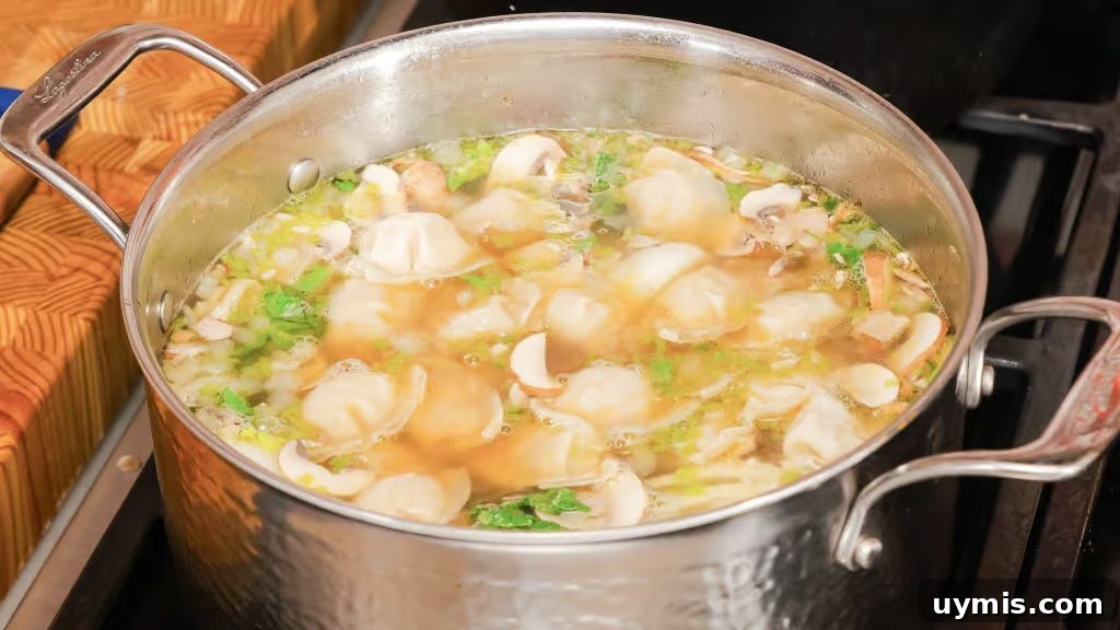 Homemade Wonton Soup Recipe with Pork and Shrimp 5 Homemade wonton soup with shrimp, bok choy, mushrooms, and green onions.