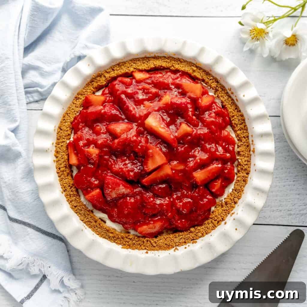 Lemon Icebox Pie Recipe with Creamy No Bake Filling 11 Strawberry pie with a pie server and flowers around.