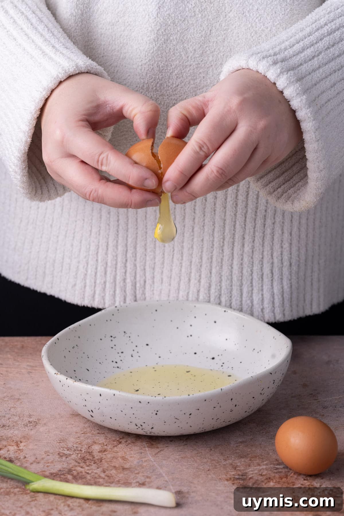 Smoked Salmon Omelet with Lox and Schmear, 5 Ingredients 4 Cracking eggs into a shallow bowl to beat to make an omelet.