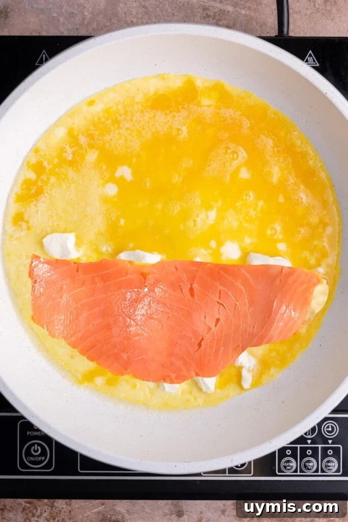 Smoked Salmon Omelet with Lox and Schmear, 5 Ingredients 8 Lox on top of blobs of cream cheese in omelet.