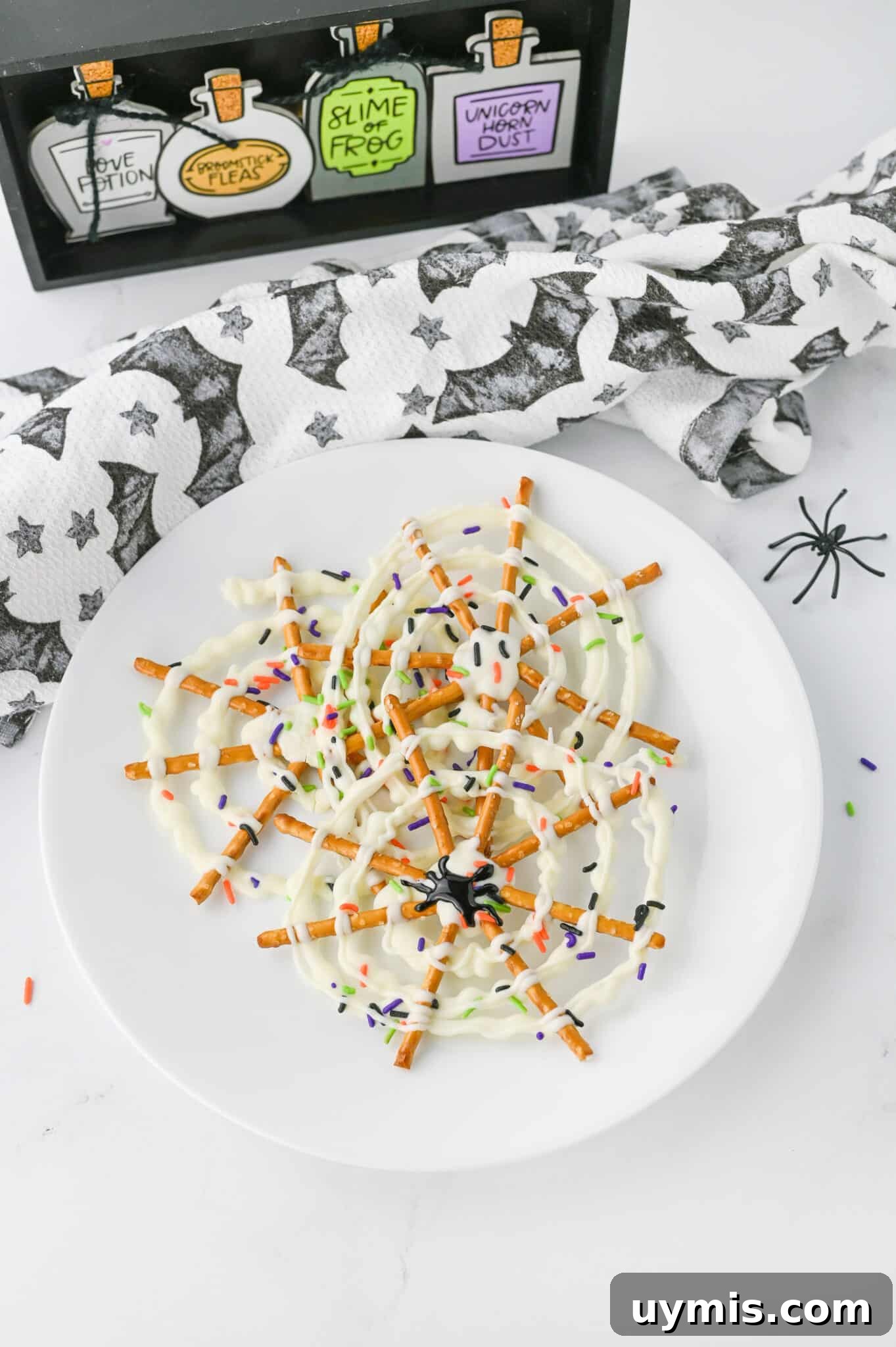 How to Make Spider Web Pretzels for Halloween 2 spider web pretzels on white plate