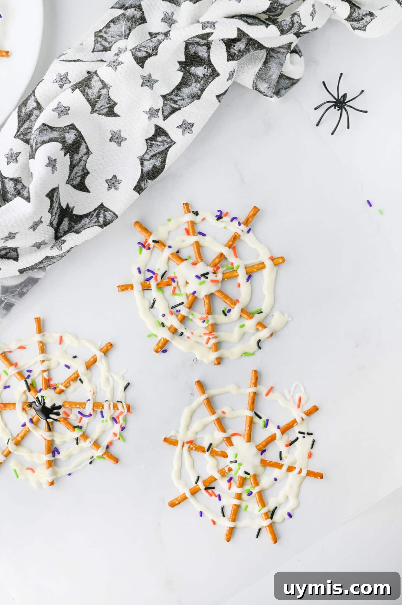 How to Make Spider Web Pretzels for Halloween 4 spider web pretzels on white table