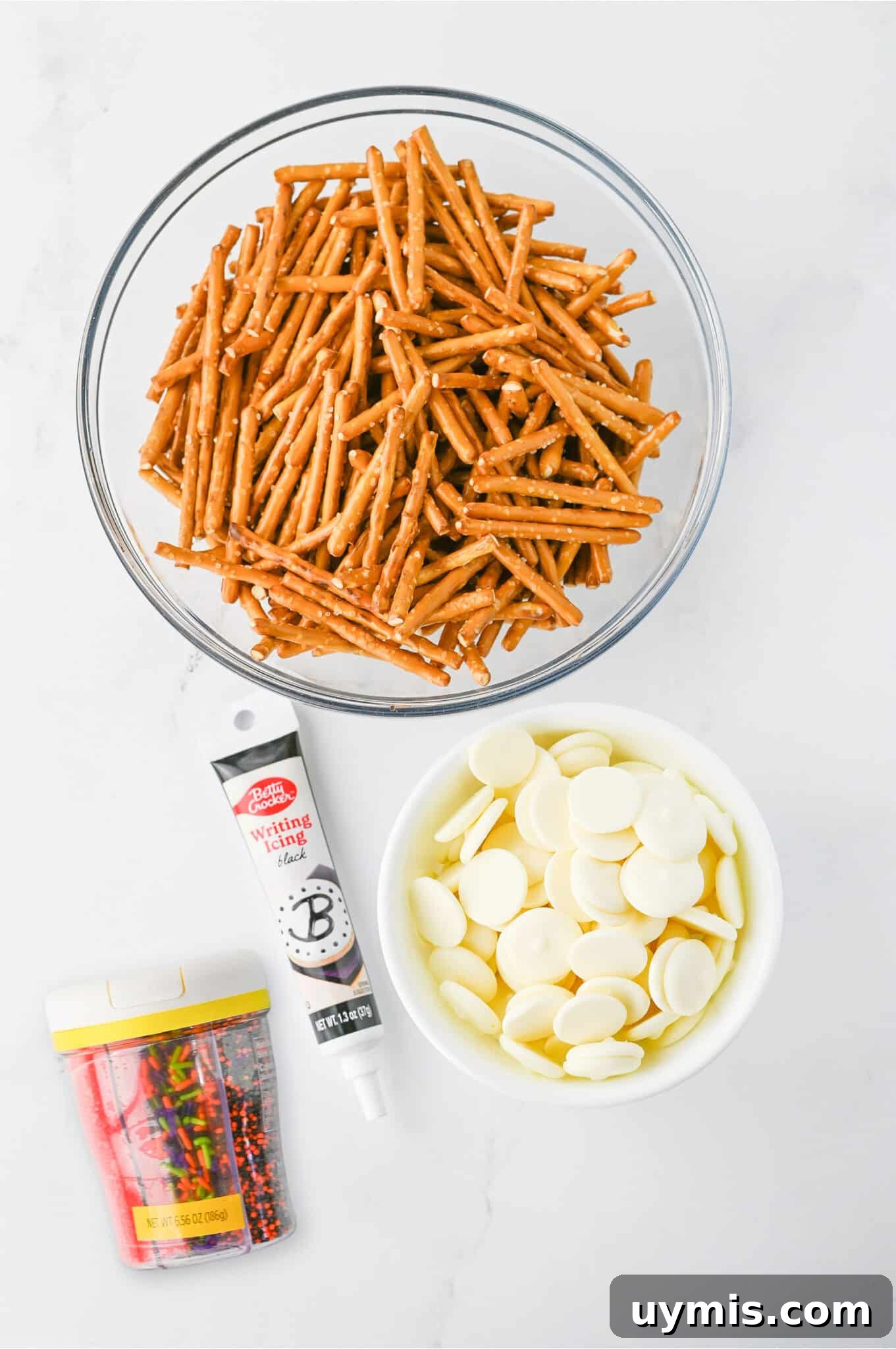 How to Make Spider Web Pretzels for Halloween 5 spider web pretzel ingredients on white table